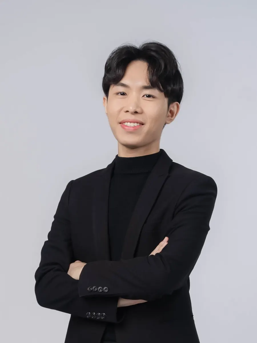 Derrick Ching, HRD Corp Accredited Trainer, in a black blazer with arms crossed
