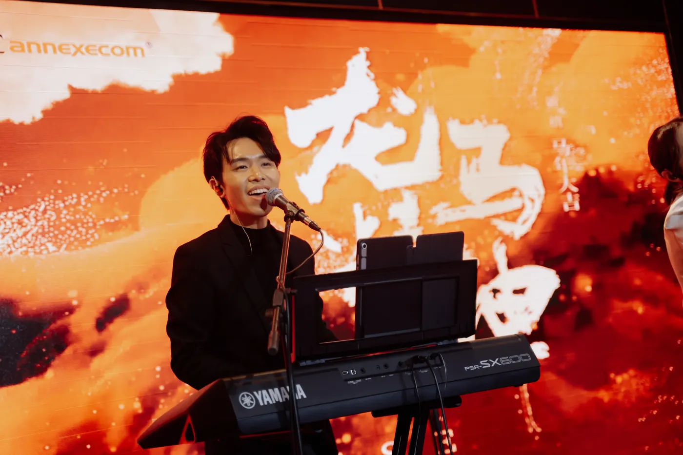 Derrick Ching singing and playing keyboard at a corporate event