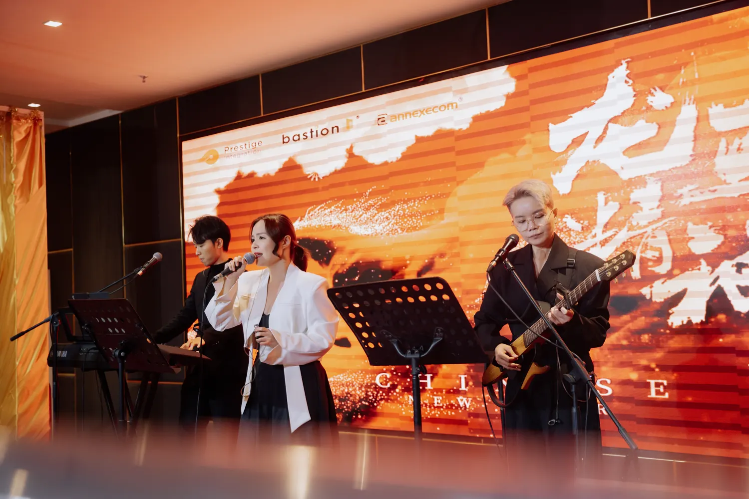 Three-piece live band performing at a corporate annual dinner in Malaysia